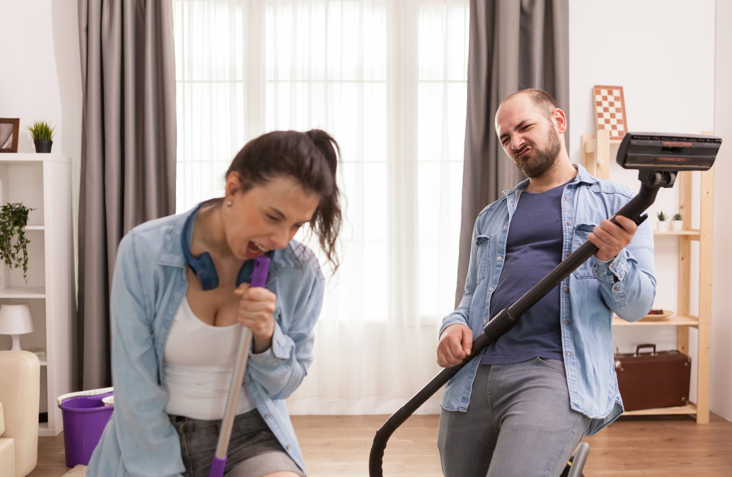 Husband Wife Singing Together While Cleaning Apartment Scaled 1