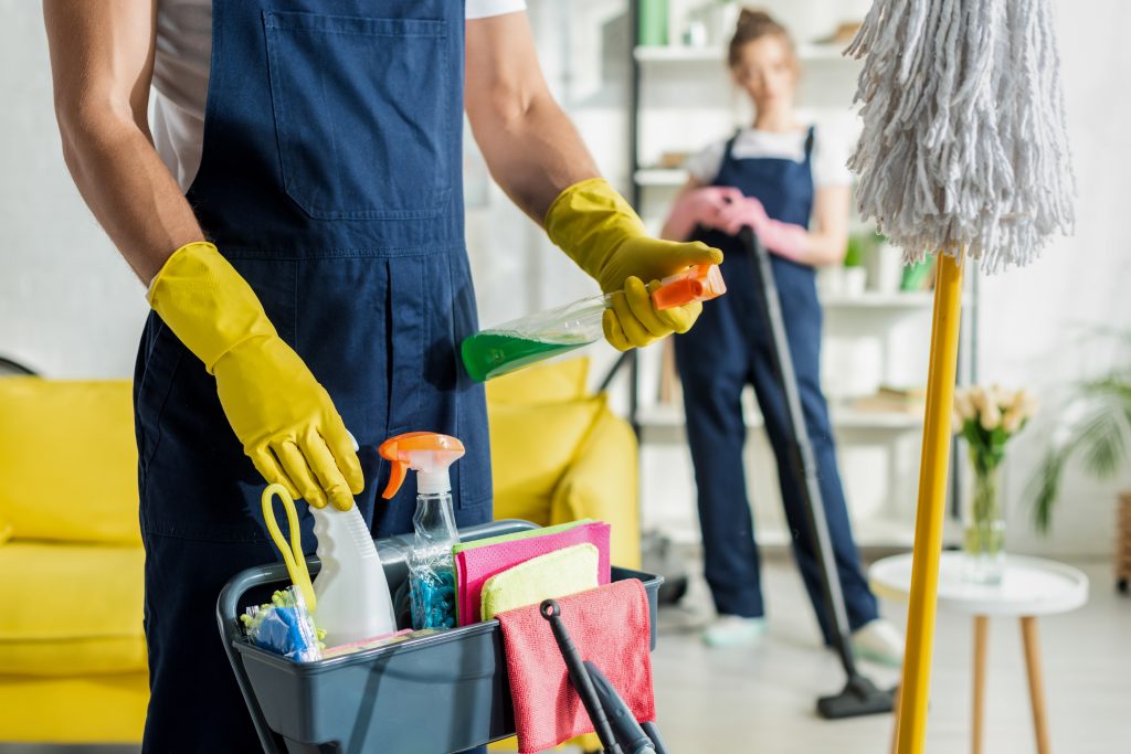 Selective,Focus,Of,Cleaner,Holding,Spray,Bottle,Near,Cleaning,Trolley