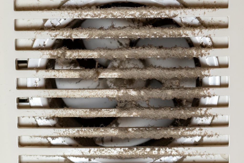 Dirty and dusty exhaust fan propeller and grill