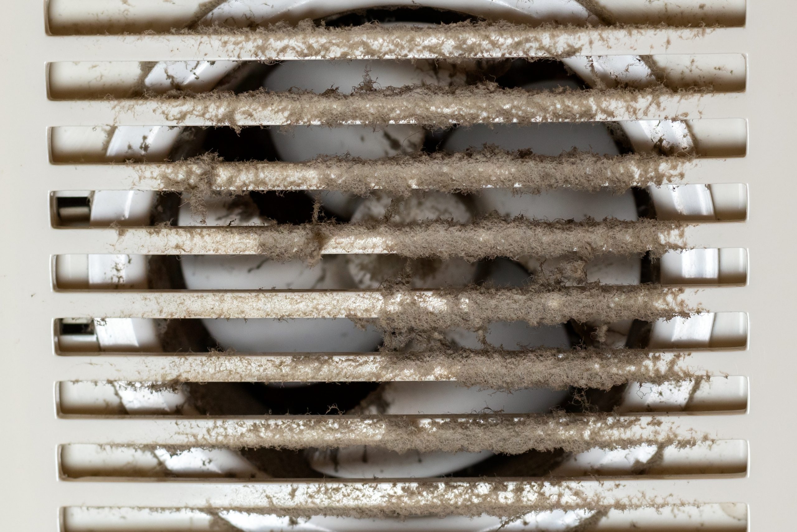 Dirty and dusty exhaust fan propeller and grill